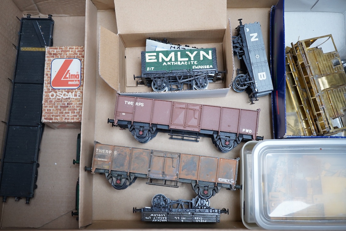 Eleven 0 gauge model railway items including; a bogie stake wagon, two mineral wagons, a North British coal wagon and two further open wagons, a partly constructed brake van, together with a Lima LMS 4F locomotive, two L
